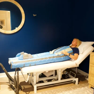 Lymphatic compression room at RestFuel Wellness featuring a Ballancer Pro suit on a treatment bed in a clean, coastal vibe.