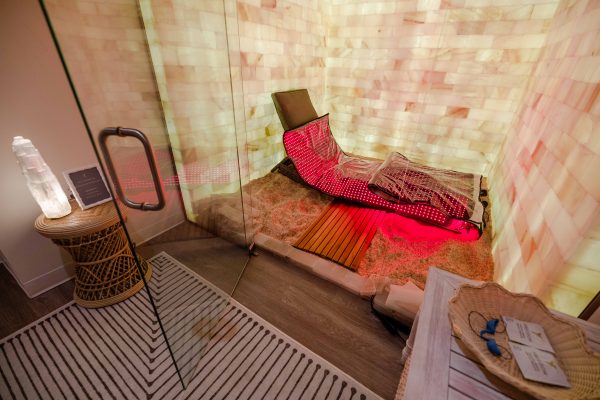 Private salt room with Himalayan salt walls, red light therapy pads, and a serene, spa-like atmosphere.